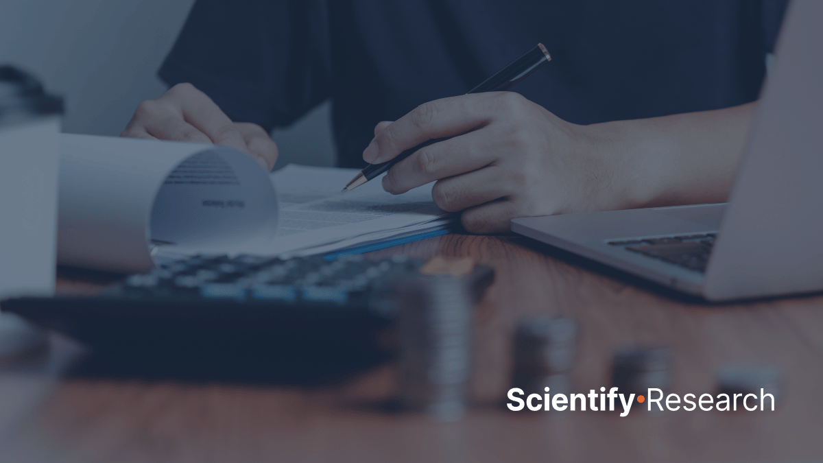 Stock photo of a person with a calculator and some papers. ScientifyResearch logo.