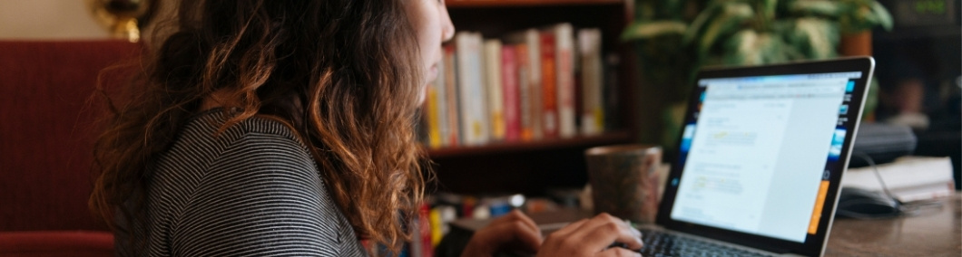 Researcher working at a desk in a quiet academic workspace